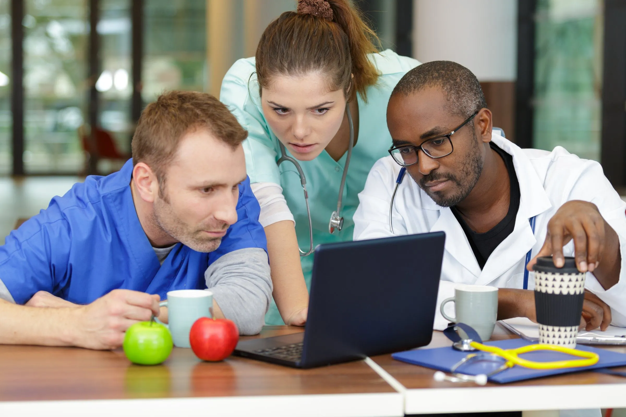 A rehab team reviewing audit results together on a laptop