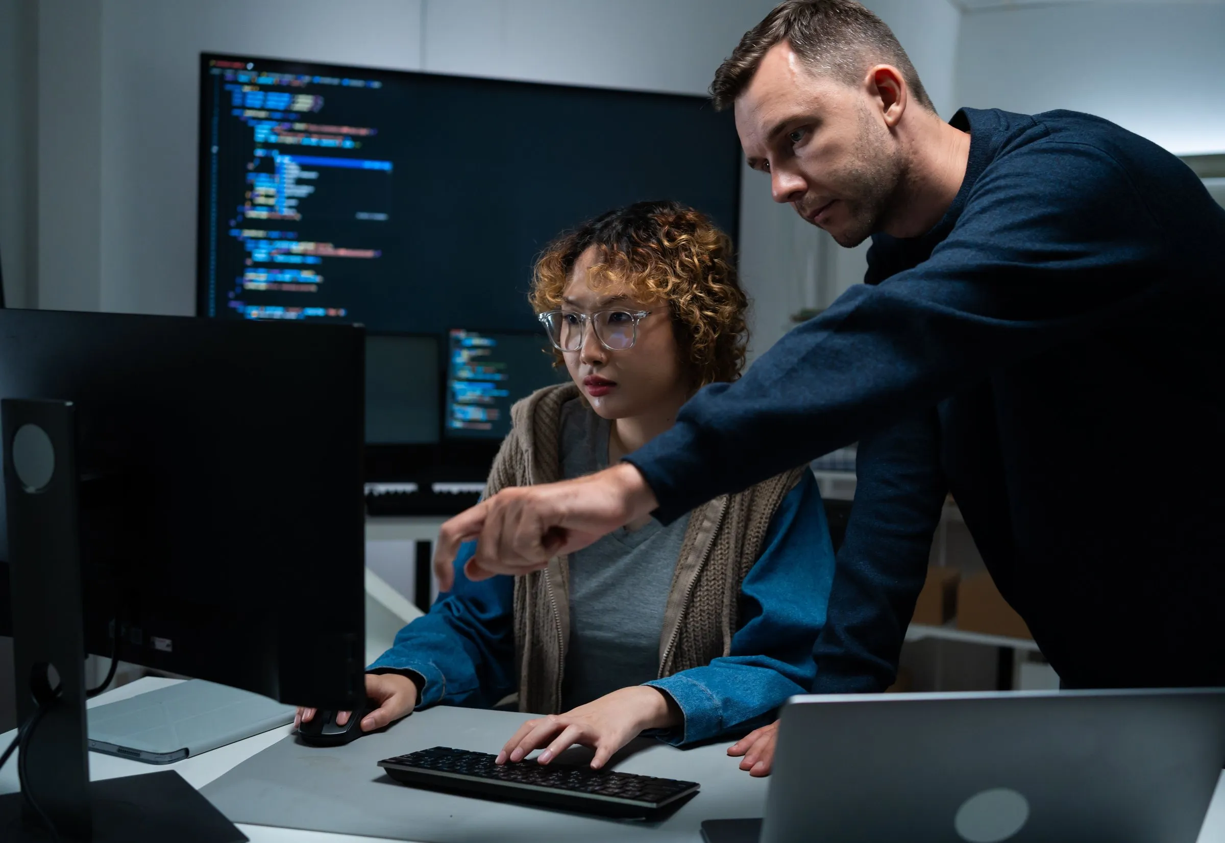 Two engineers reviewing code together